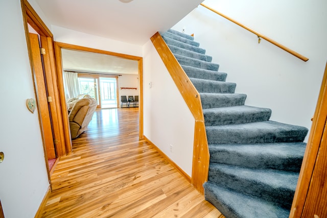 stairs with hardwood / wood-style flooring