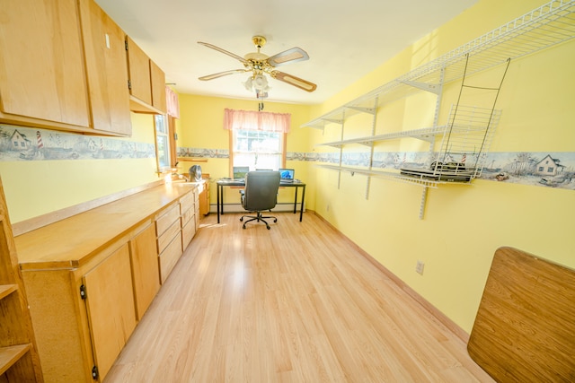 kitchen with built in desk, light hardwood / wood-style flooring, and ceiling fan