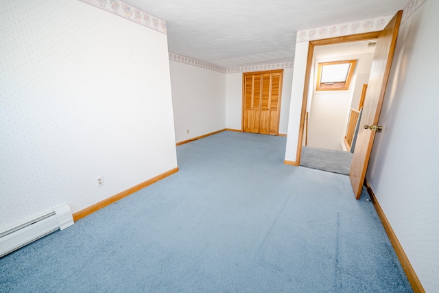 unfurnished bedroom with a baseboard heating unit and light colored carpet