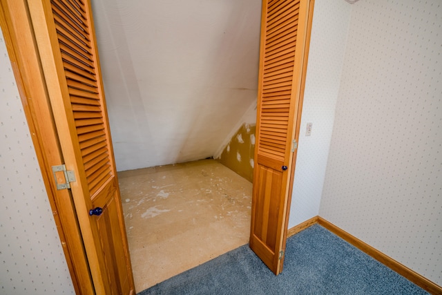 interior space with lofted ceiling and carpet floors