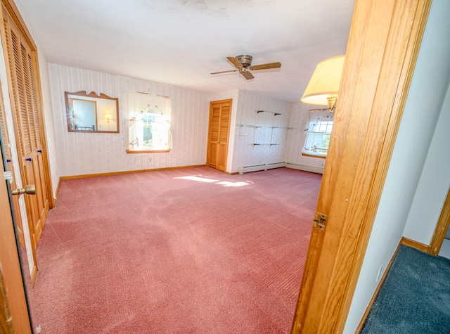 unfurnished living room with a healthy amount of sunlight, ceiling fan, and carpet flooring