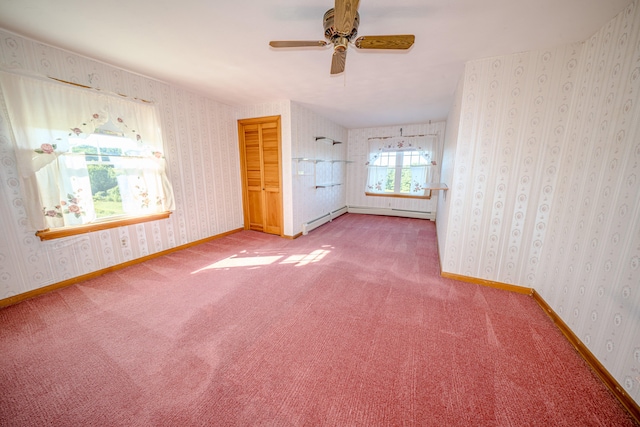 carpeted empty room with baseboard heating and ceiling fan