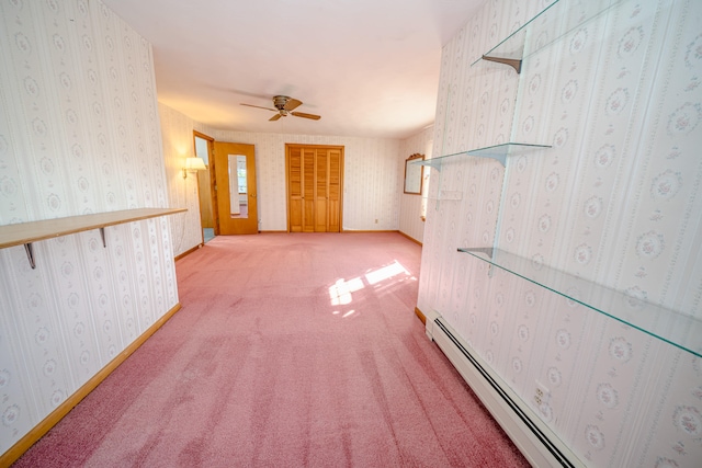 hall featuring a baseboard heating unit and light colored carpet