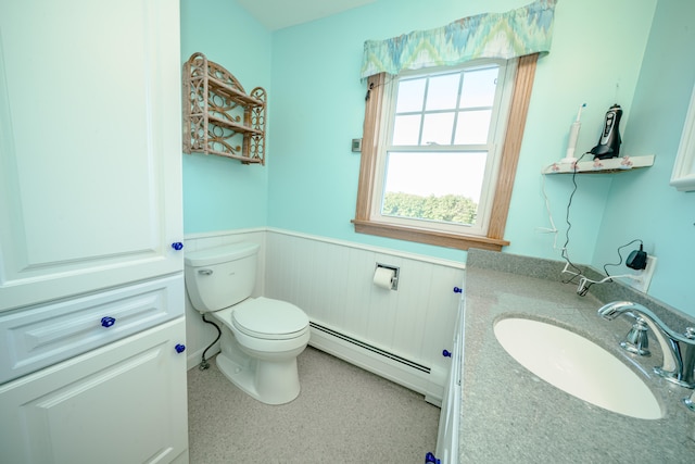 bathroom with a baseboard heating unit, toilet, and vanity