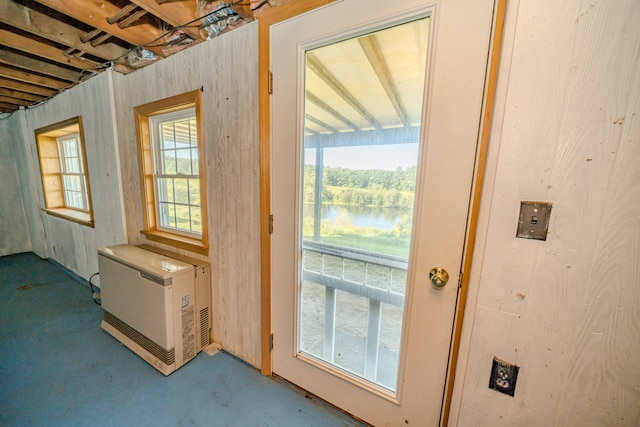 doorway to outside with a water view and concrete flooring