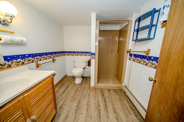 bathroom with a baseboard heating unit, hardwood / wood-style floors, toilet, walk in shower, and vanity