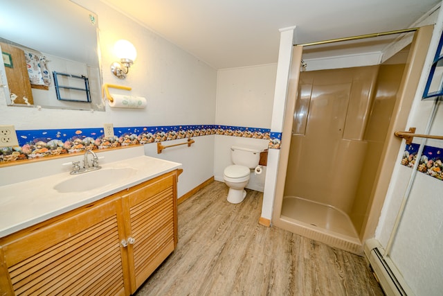 bathroom with vanity, a baseboard radiator, hardwood / wood-style floors, toilet, and a shower