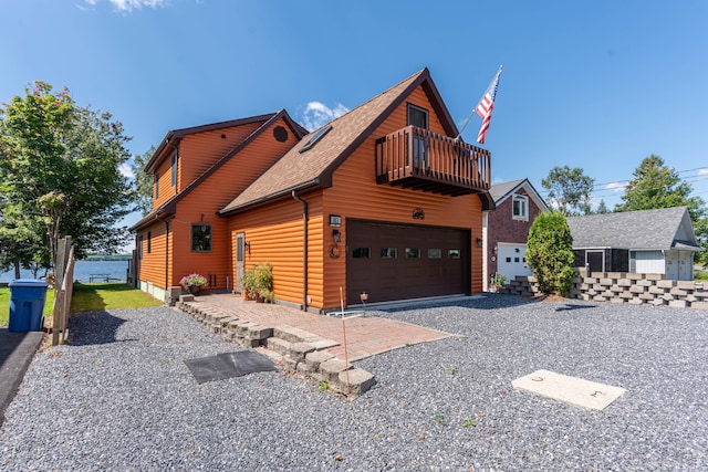 view of side of property with a garage and a balcony