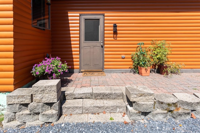 803 Lake Shore Rd, Madawaska, ME 04773 - view of exterior entry with faux log siding