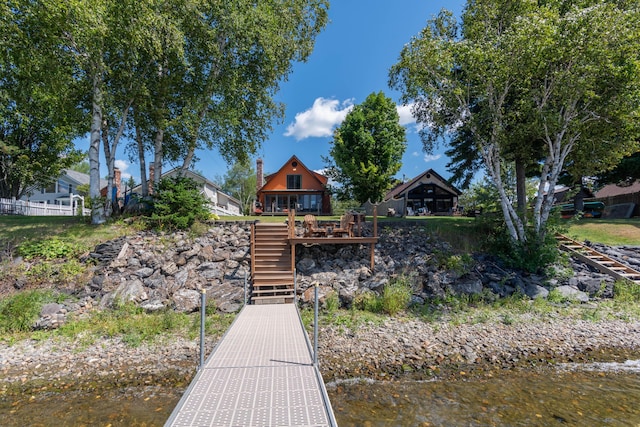803 Lake Shore Rd, Madawaska, ME 04773 - back of property featuring a deck with water view, a chimney, and stairway