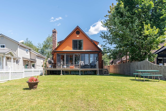 803 Lake Shore Rd, Madawaska, ME 04773 - back of house featuring a fenced backyard, a chimney, a wooden deck, and a yard