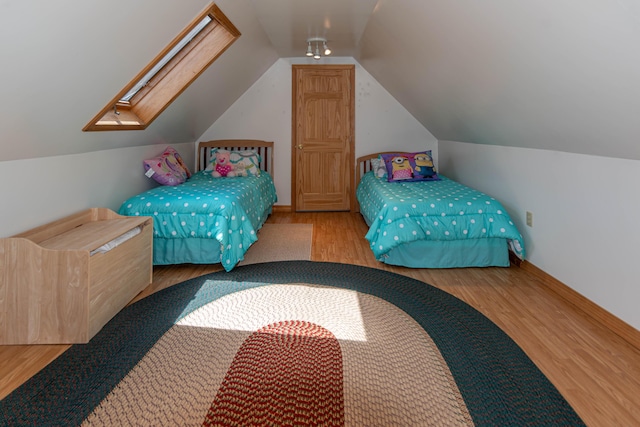 803 Lake Shore Rd, Madawaska, ME 04773 - bedroom featuring baseboards, lofted ceiling, and wood finished floors