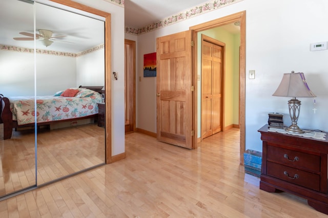 803 Lake Shore Rd, Madawaska, ME 04773 - bedroom featuring a ceiling fan, light wood-style flooring, and baseboards