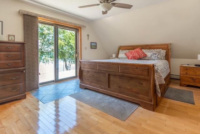 803 Lake Shore Rd, Madawaska, ME 04773 - bedroom featuring baseboard heating, light wood-style flooring, lofted ceiling, and access to outside