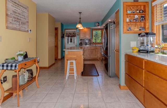 803 Lake Shore Rd, Madawaska, ME 04773 - kitchen with light countertops, light tile patterned floors, and freestanding refrigerator