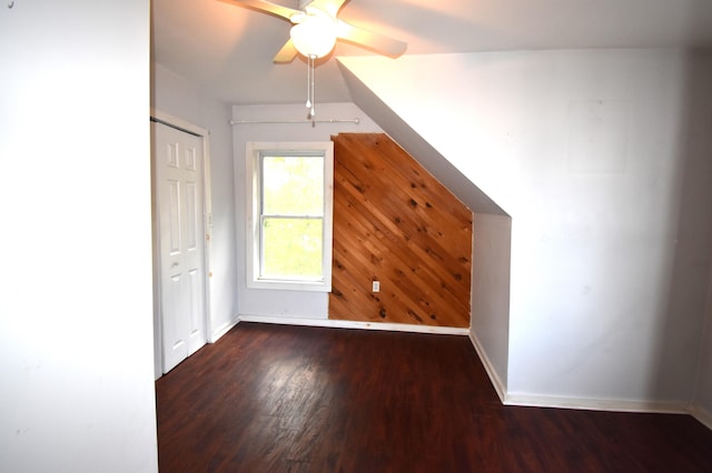 bonus room with ceiling fan and dark hardwood / wood-style floors