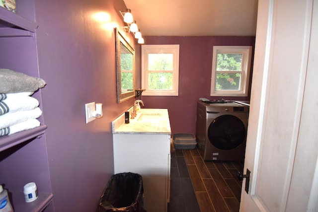 bathroom featuring wood-type flooring, washer / clothes dryer, and vanity