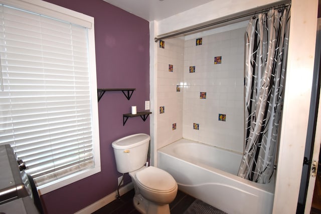 bathroom with shower / bath combination with curtain and toilet