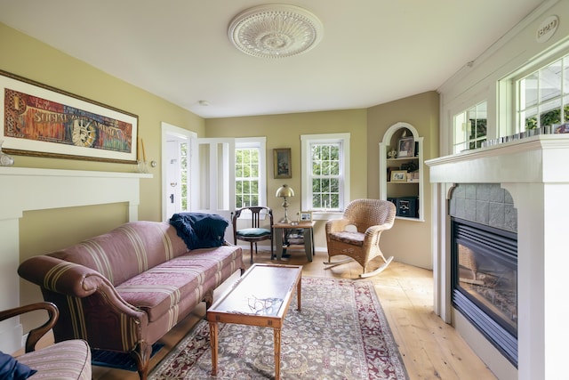 living area with a fireplace and light wood finished floors