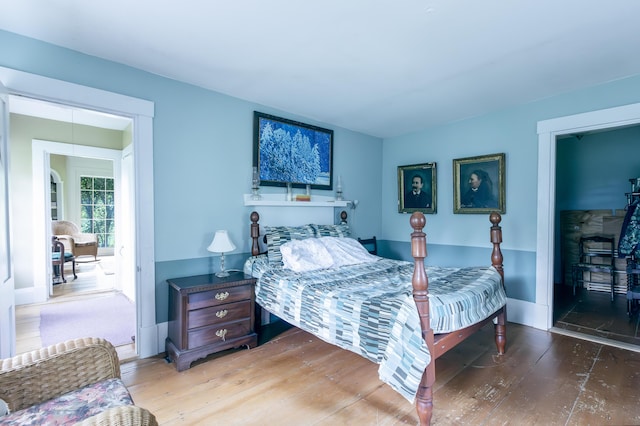 bedroom with light wood-style flooring and baseboards