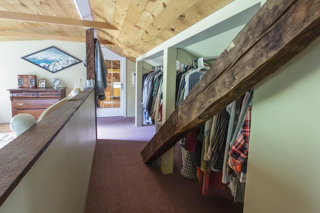 interior space featuring lofted ceiling, carpet floors, an upstairs landing, and wood ceiling