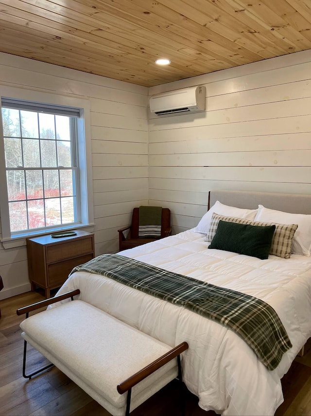 bedroom with a wall mounted AC, dark hardwood / wood-style flooring, wooden walls, and wood ceiling