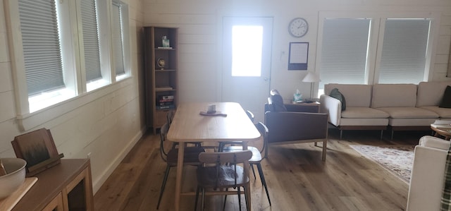 dining space with wood-type flooring and a healthy amount of sunlight