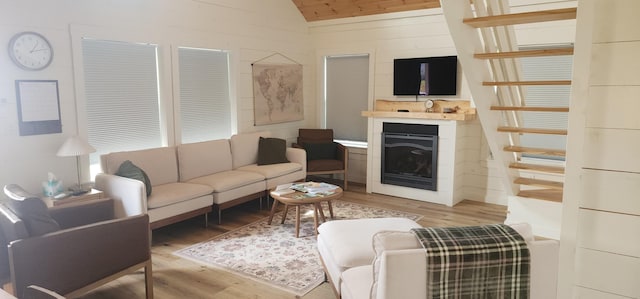 524A Ridge Rd, Oakfield, ME 04780 - living area featuring a fireplace, light wood finished floors, and vaulted ceiling