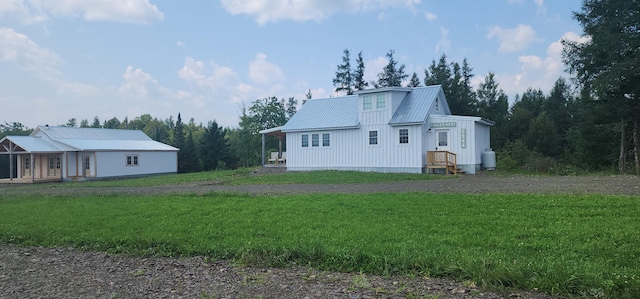 524A Ridge Rd, Oakfield, ME 04780 - rear view of house with metal roof and a yard