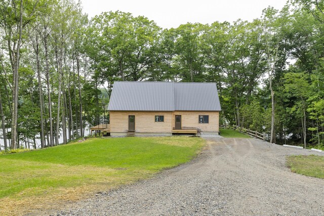 view of front of house featuring a deck and a front lawn