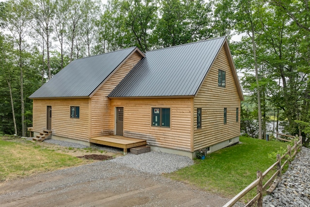 rear view of house featuring a yard