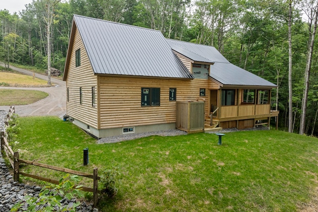 back of house featuring a lawn