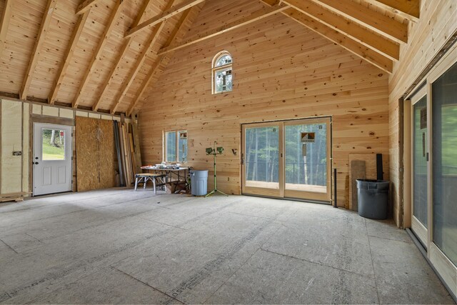 unfurnished living room featuring high vaulted ceiling, wood ceiling, beamed ceiling, and a wood stove