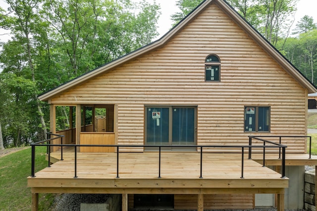 rear view of house with a wooden deck