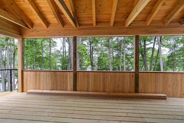 unfurnished sunroom with wooden ceiling and vaulted ceiling with beams