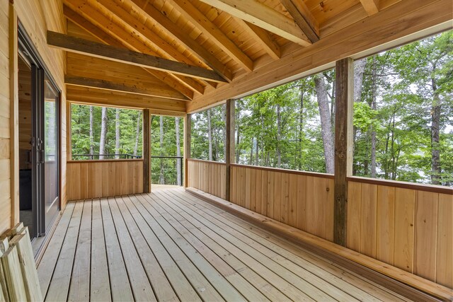 unfurnished sunroom with wooden ceiling and vaulted ceiling with beams