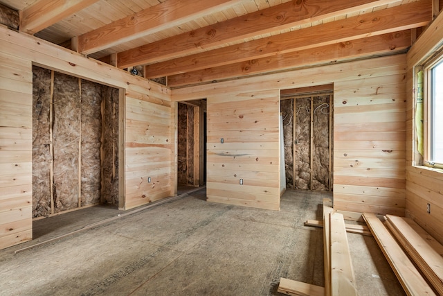 unfurnished room with wood walls