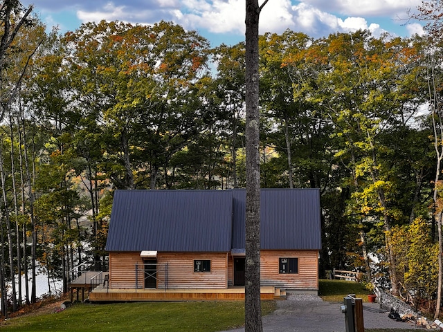 view of property exterior featuring a deck and a lawn