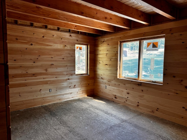 spare room featuring wooden walls