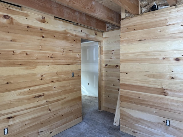 corridor featuring wood walls and carpet flooring