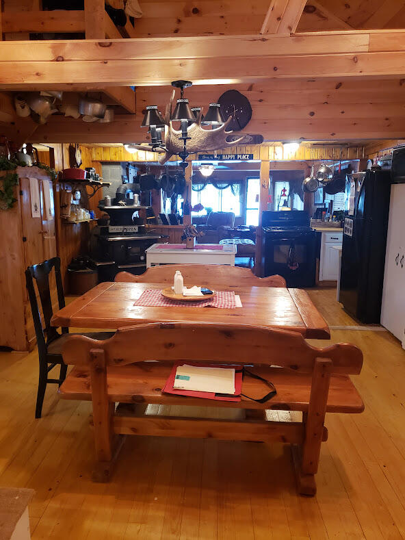 dining area featuring wood walls and light wood-type flooring