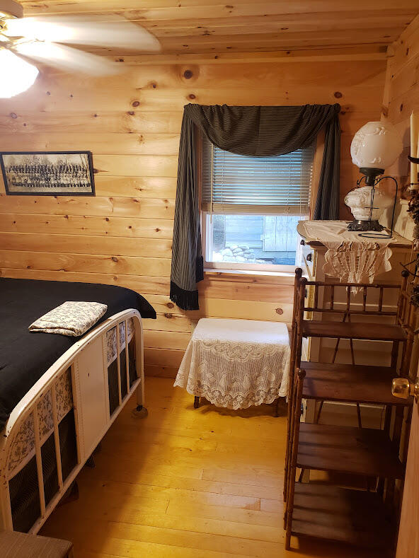 bedroom with wood ceiling and light hardwood / wood-style floors