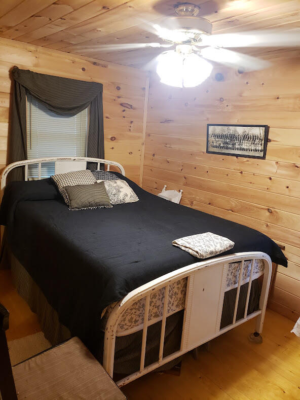 bedroom featuring wood ceiling, ceiling fan, and hardwood / wood-style floors