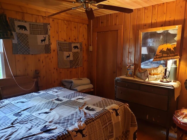 bedroom with wood walls, wood ceiling, and ceiling fan