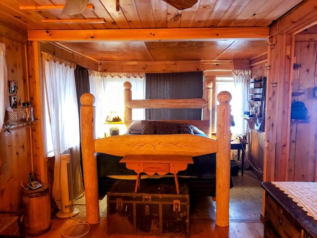 bedroom with hardwood / wood-style flooring, wooden walls, and wood ceiling