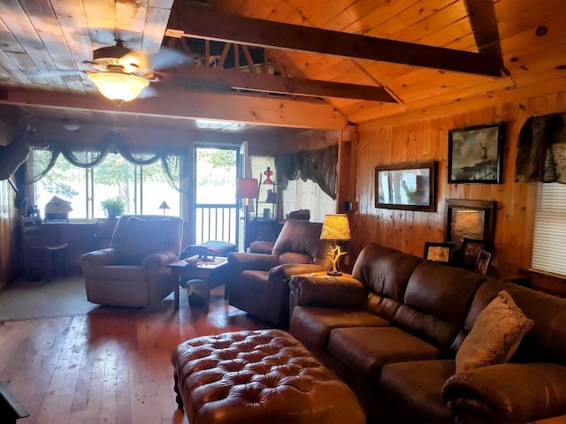 living room with vaulted ceiling with beams, wood ceiling, and hardwood / wood-style floors