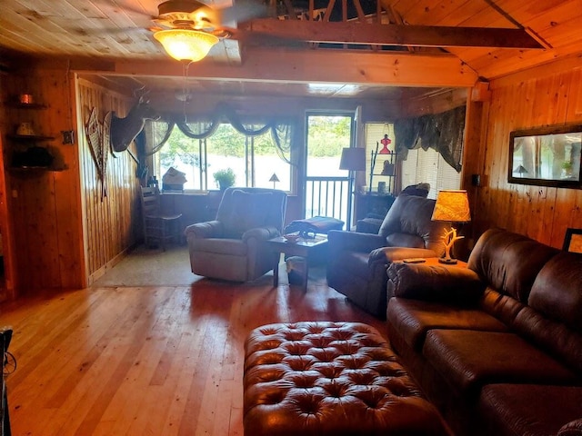 living room featuring ceiling fan, light hardwood / wood-style floors, wood walls, and wooden ceiling