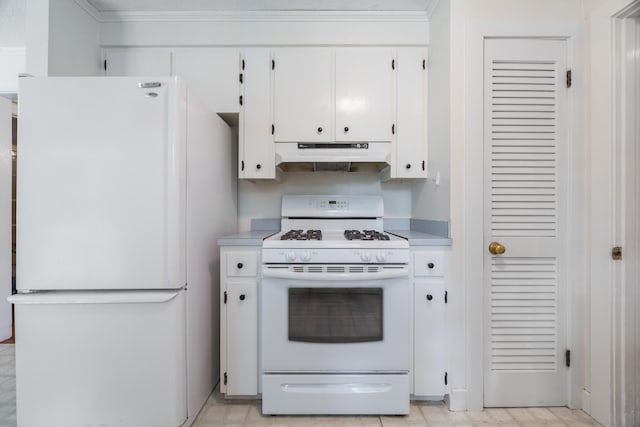 kitchen featuring light tile patterned floors, white cabinets, and white appliances