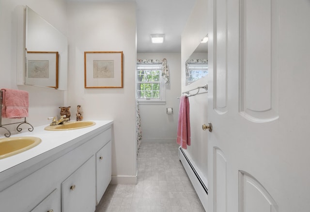 bathroom featuring double vanity, a baseboard radiator, and tile patterned floors