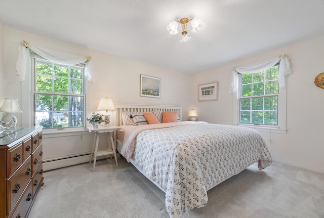 bedroom featuring light carpet and baseboard heating